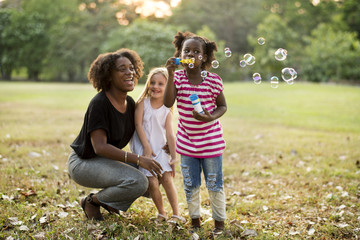 Children is playing bubbles in a park