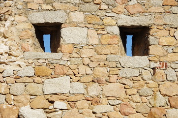 Narrow windows on a medieval wall