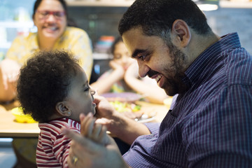 Brazilian father playing with daughter