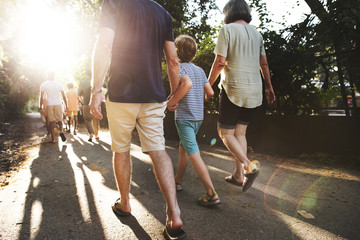 Rear view of caucasian family walking outdoors together