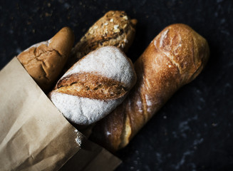 Baguettes on paper bag with black background