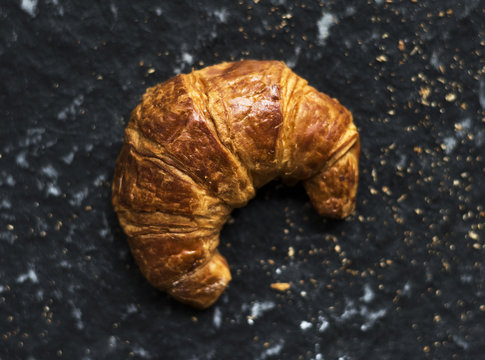 Crossiant butter single on black background