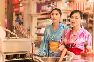 Japanese women choosing street food snack