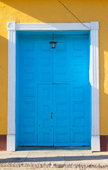 Typical colonial building with small doors in the big gate, Cuba