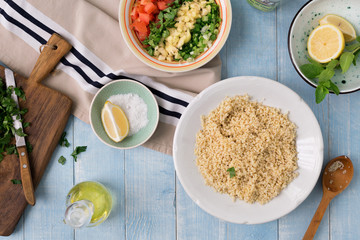 Ingredients for cooking vegetarian salad on blue rustic wooden table