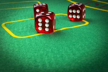 risk concept - playing dice on a green gaming table. Playing a game with dice. Red casino dice rolls. Rolling the dice concept for business risk, chance, good luck or gambling