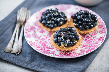 Fresh blueberry tart on vibrant plate