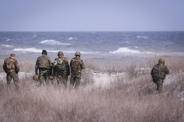 Soldiers from US Navy Amphibious Squadron 8 assault an enemy strong point during a NATO military...