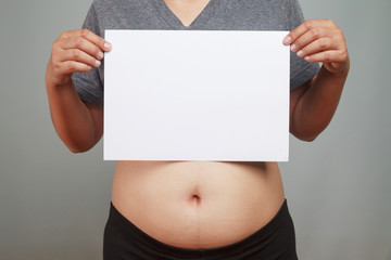 Pregnant woman holding blank paper.