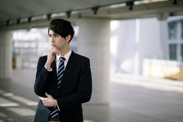 young businessman folding his arms.