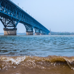 Long bridge across river in city of China.
