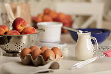 Preparation of homemade peach pie. Kitchen accessories and products.