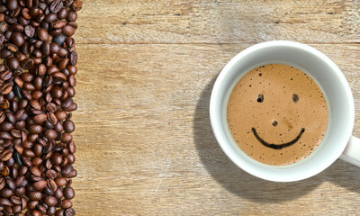 Cup and coffee with a smiling face on the coffee foam