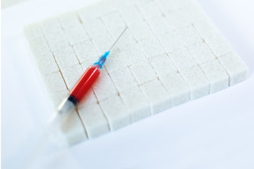 Syringe with blood and sugar cubes