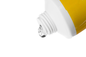 Cosmetic liquid pouring from bottle isolated on white background