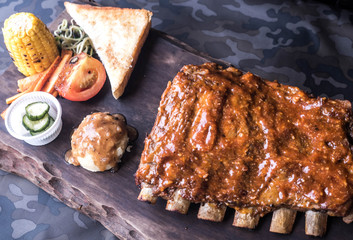 Pork ribs and pickles Grilled vegetables on a wooden tray