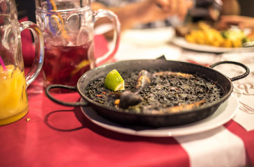 Black rice Paella recipe for two in traditional pan, recipe from Mediterranean