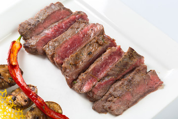 Juicy steak medium rare beef with spices and grilled vegetables