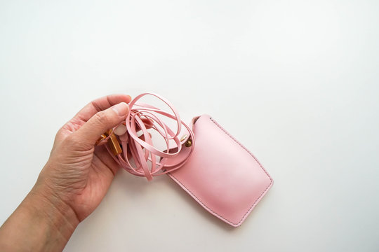 isolated pull pink cute earphone from leather case for listening to music