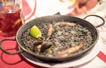 Black rice Paella recipe for two in traditional pan, recipe from Mediterranean