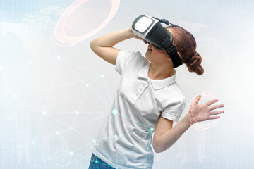 Portrait of little girl having fun with virtual reality headset on light background