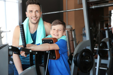 Fototapeta premium Dad and son training in gym