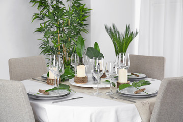 Beautiful table setting with green tropical leaves