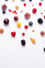 Mix of berries isolated over white background table.