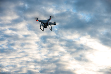 The flying drone on the beautiful sky background