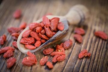 Goji Berries (selective focus) on vintage wooden background