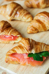 Sandwiches with butter croissants, smoked salmon and parsley. Breakfast meal. Starter and appetizer