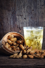 Boiled Peanuts and beer on wood background