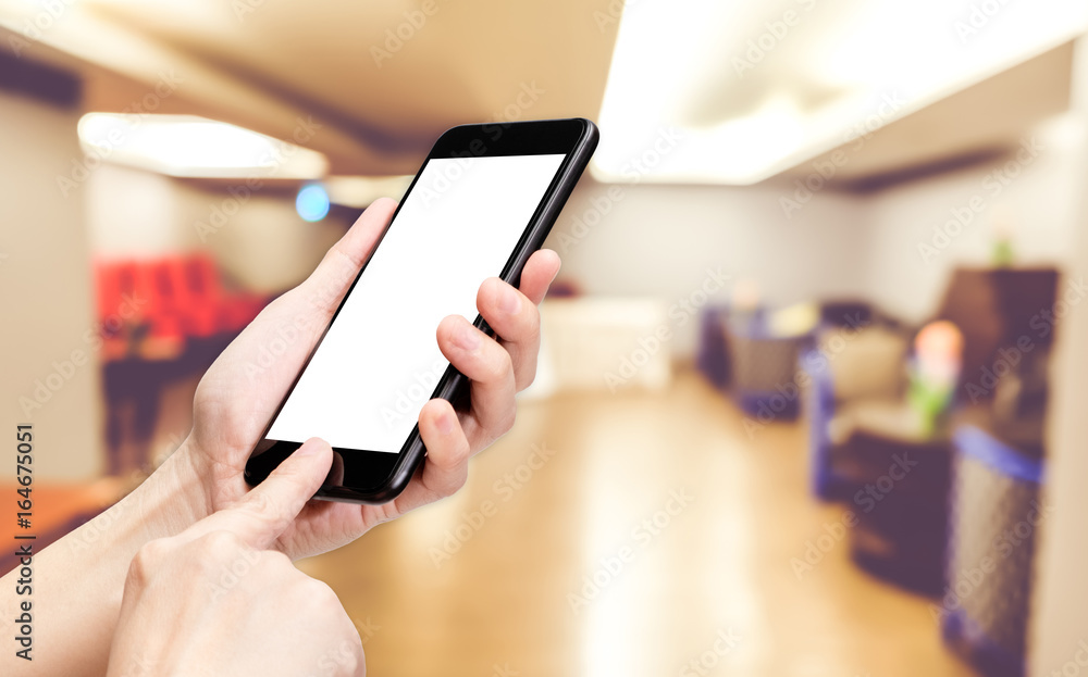 Fototapete Hand click mobile phone with blur seminar hall room background bokeh light,White screen mock up template for adding your design or your text