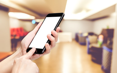 Hand click mobile phone with blur seminar hall room background bokeh light,White screen mock up template for adding your design or your text