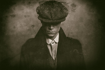 Antique wet plate photo of mysterious 1920s english gangster with flat cap. - obrazy, fototapety, plakaty
