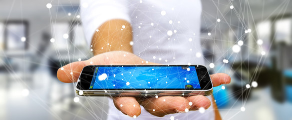 Businessman holding flying network sphere over his mobile phone 3D rendering