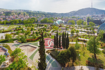 Aerial panorama view on park Rike, modern landmark with pathways, art benches and different plants. Tbilisi, Georgia.