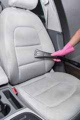 Before chemical cleaning process a professionally nozzle releasing a car textile seats from dust. Early spring cleaning or regular clean up. 