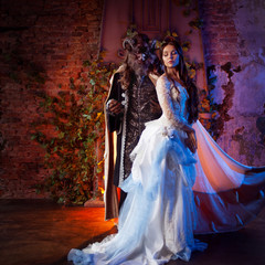 Fine art photo of beauty and beast. Beautiful girl and a monster, fairy tale, concept