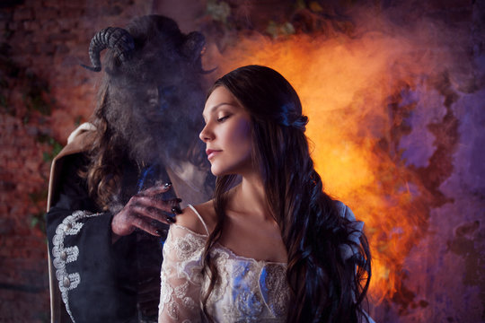 Fine art photo of beauty and beast. Beautiful girl and a monster, fairy tale, concept