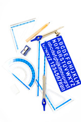 pen, ruler and setsquare on white background