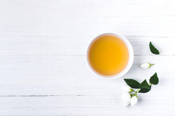 Green tea with a jasmine in white cups. Negative space for text or disign