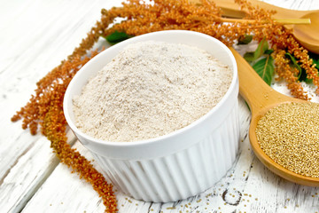 Flour amaranth in bowl with spoon on board