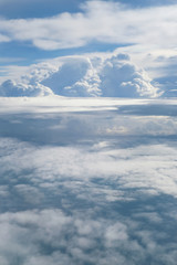 Aerial view from the plane of fluffy rain cloud in daytime - Cloudscape