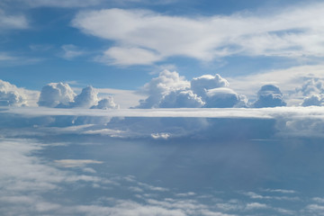 Aerial view from the plane of fluffy rain cloud in daytime - Cloudscape