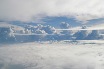 Aerial view from the plane of fluffy rain cloud in daytime - Cloudscape