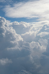 Aerial view from the plane of fluffy rain cloud in daytime - Cloudscape
