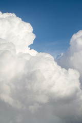 Aerial view from the plane of fluffy rain cloud in daytime - Cloudscape