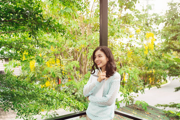 Young attractive sweet girl with notepad on a veranda. Spring mood.