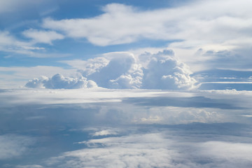 Aerial view from the plane of fluffy rain cloud in daytime - Cloudscape